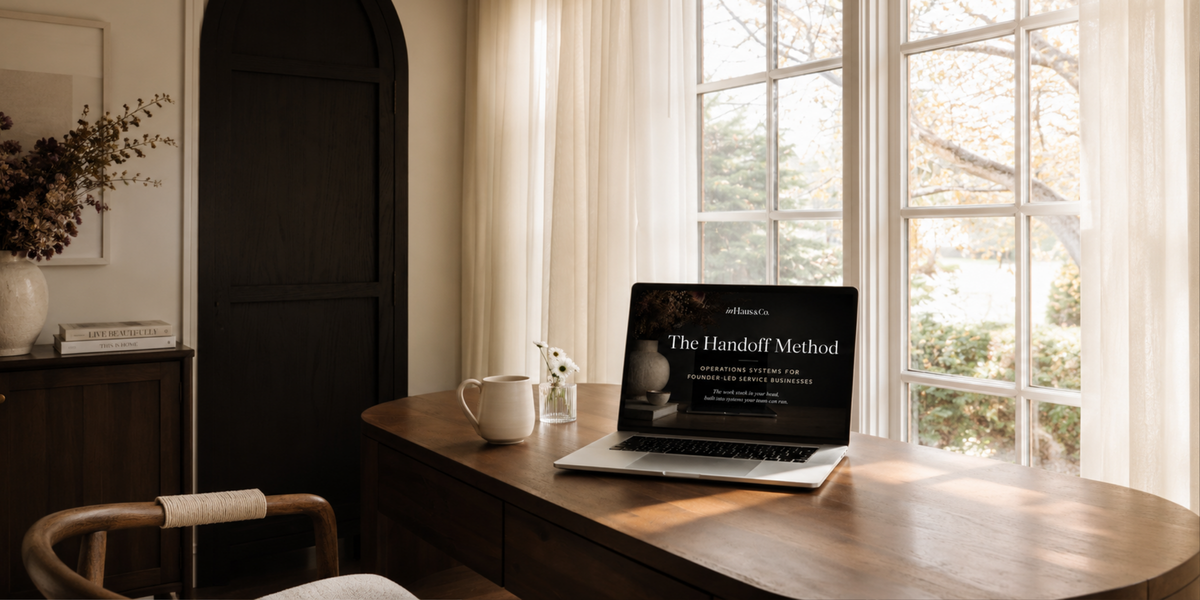 A moody desk scene with a laptop and lamp, suggesting a founder's workspace after hours.